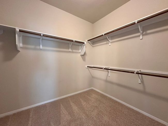 Spacious closet with carpet flooring | Image 15