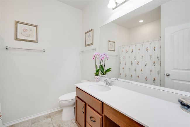 Full bath with vanity, tile patterned floors, and curtained shower | Image 15