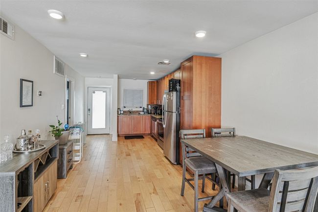 Dining space with light wood-style flooring and recessed lighting | Image 4