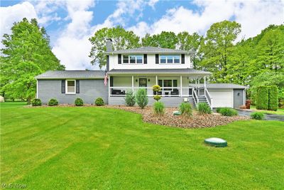 View of front of property with a garage, a front yard, and covered porch | Image 2