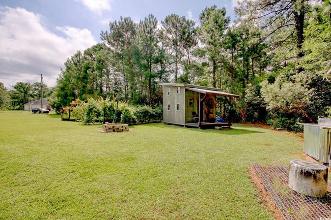 View of grassy yard with an outbuilding | Image 39