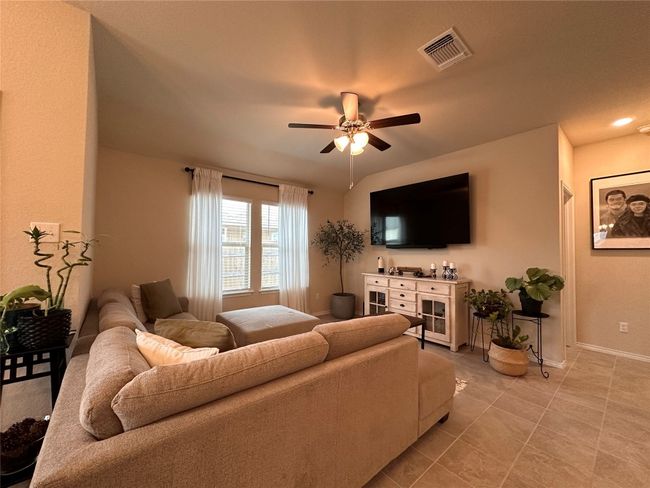 Living room featuring ceiling fan, baseboards, and light tile patterned flooring | Image 25