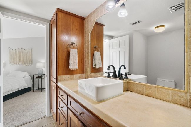 Ensuite bathroom featuring vanity, toilet, visible vents, and tile patterned flooring | Image 20