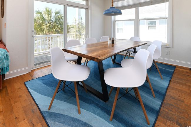 Dining area featuring baseboards and wood finished floors | Image 6