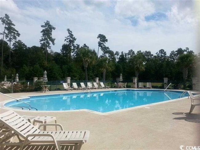 Community pool with fence and a patio area | Image 33