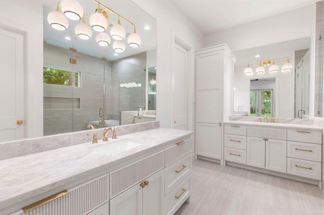 Separate vanities with plenty of space, lighting, and storage. | Image 15