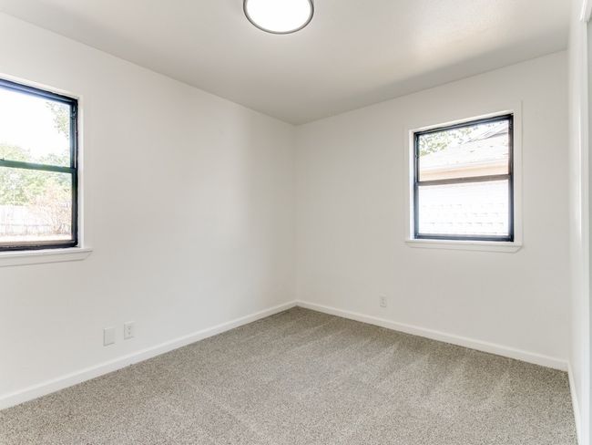 Unfurnished room featuring carpet flooring, baseboards, and a wealth of natural light | Image 6