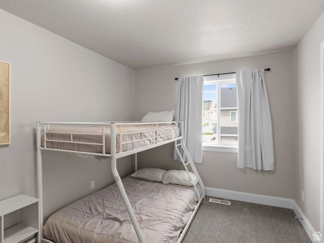 Carpeted bedroom featuring baseboards and visible vents | Image 18