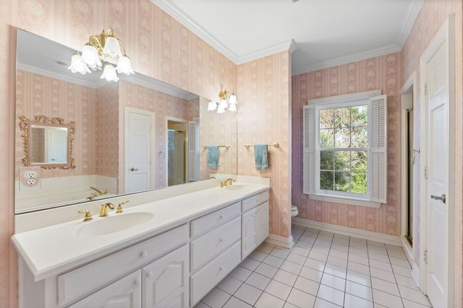 Full bath with double vanity, crown molding, and baseboards | Image 26