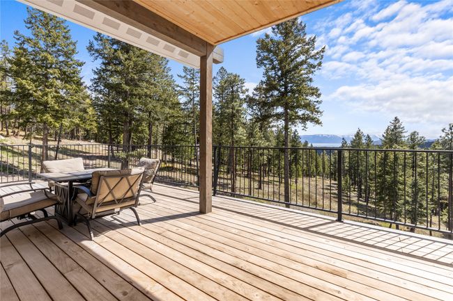 Deck featuring a mountain view and outdoor dining space | Image 19