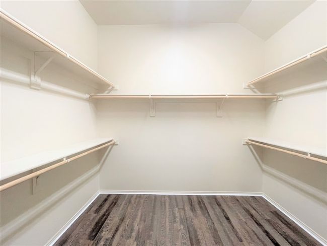 Walk in closet with wood finished floors | Image 10