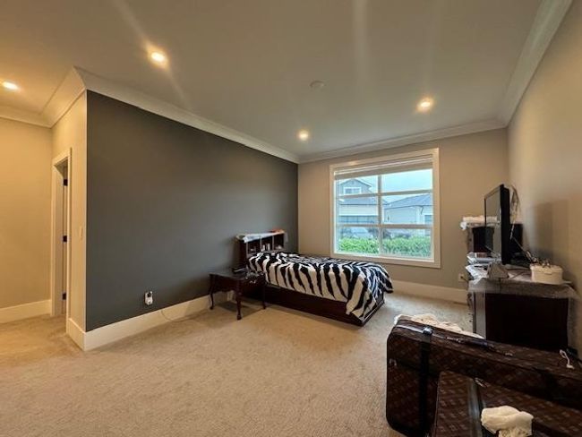 Bedroom with carpet floors, baseboards, and ornamental molding | Image 25