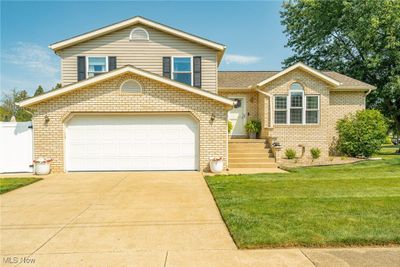 Split level home with a garage and a front yard | Image 1