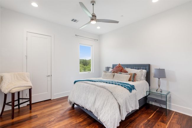 A light-filled bedroom offering comfort and a glimpse of Lake Austin. | Image 33