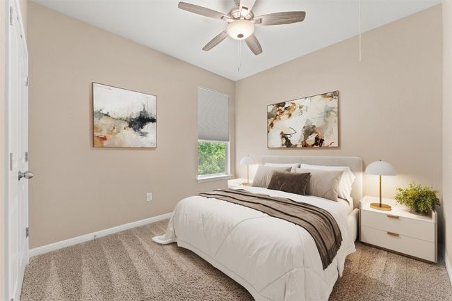 Bedroom featuring attic access, light colored carpet, baseboards, and ceiling fan Virtual staging | Image 15