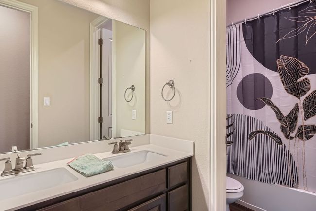 Bathroom with toilet, a sink, double vanity, and shower / tub combo | Image 24