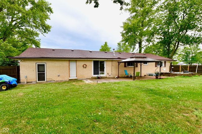 back of house with a patio area, brick siding, a fenced backyard, a gazebo, and roof with shingles | Image 4
