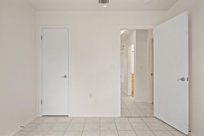 Empty room with light tile patterned floors and baseboards | Image 12