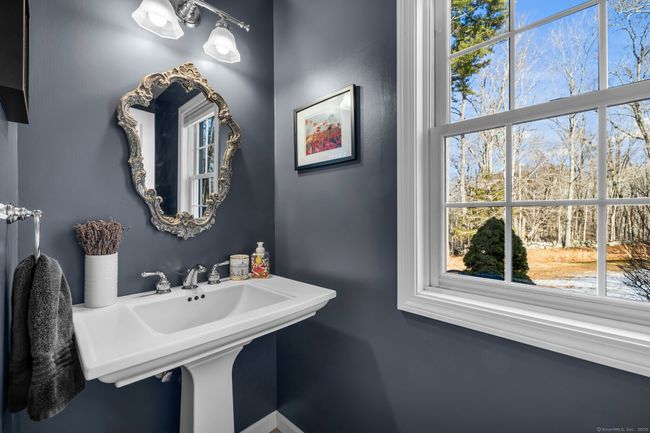 Powder room / half bath with tile floor. | Image 13