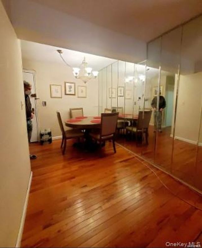 Dining space with hardwood / wood-style flooring and a chandelier | Image 15