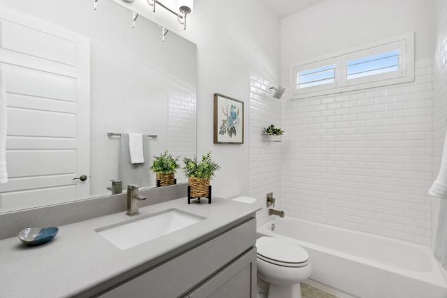 The second full bath offers a shower/tub combo with a timeless subway tile surround. | Image 29