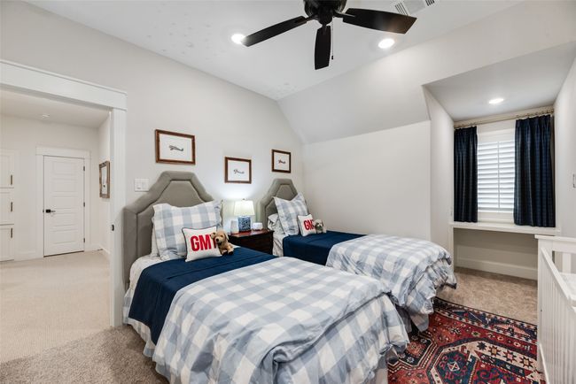 Bedroom with light carpet, lofted ceiling, ceiling fan, and baseboards | Image 34