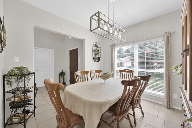 With its large windows and views of the peaceful front yard, this spacious area could also be used as a home office. | Image 7