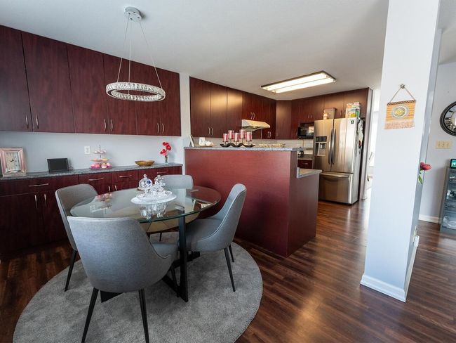 Dining space featuring baseboards and dark wood-style flooring | Image 12