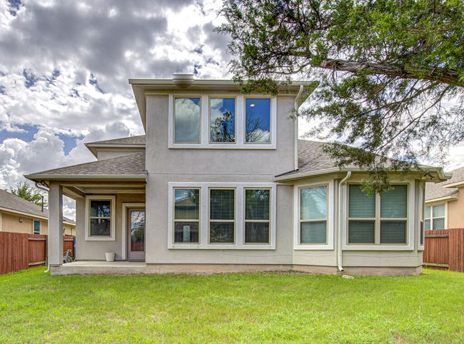 Back of property with a patio, stucco siding, and a shingled roof | Image 28