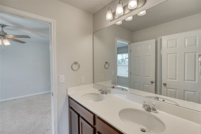 Bathroom with a sink, double vanity, and a ceiling fan | Image 28