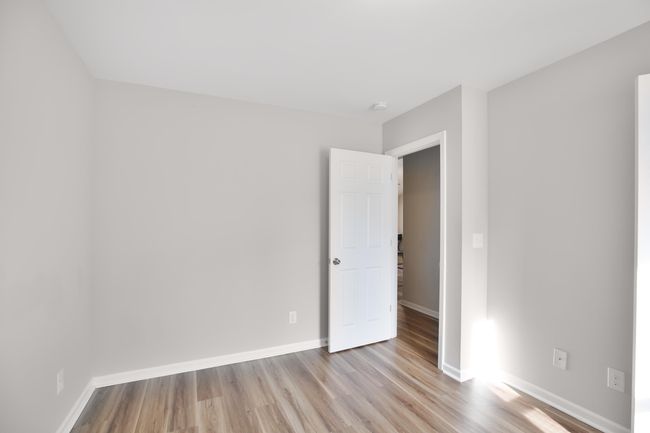 Spare room featuring wood finished floors and baseboards | Image 6
