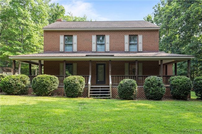 View of front of home featuring a chimney, a front lawn, and brick siding | Image 34