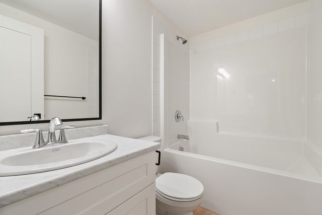 Bathroom featuring vanity and shower / washtub combination | Image 34