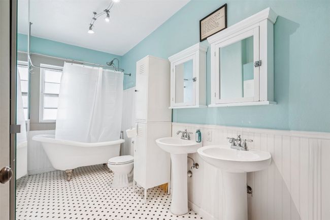 Full bathroom featuring a wainscoted wall and toilet | Image 26