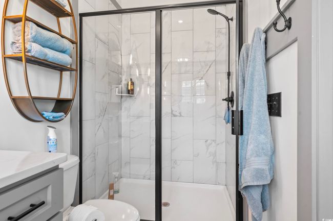 Bathroom featuring vanity, a shower stall, and toilet | Image 18