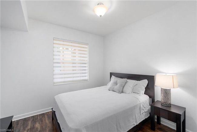 Bedroom featuring wood finished floors and baseboards | Image 14