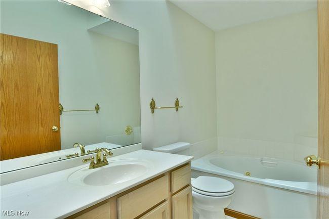 Bathroom featuring a jetted tub and vanity | Image 41