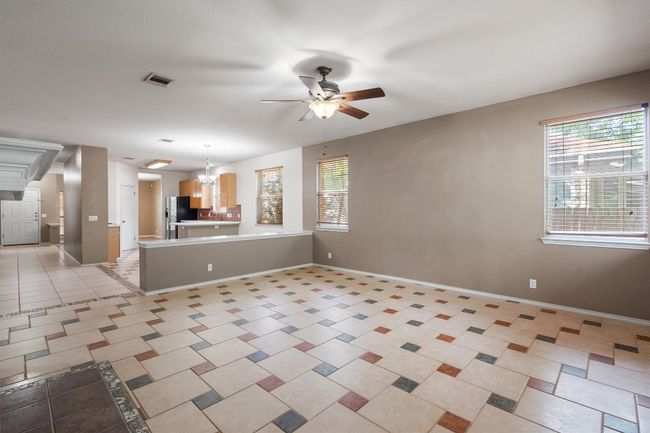 Living room with tile and ceiling fan | Image 13