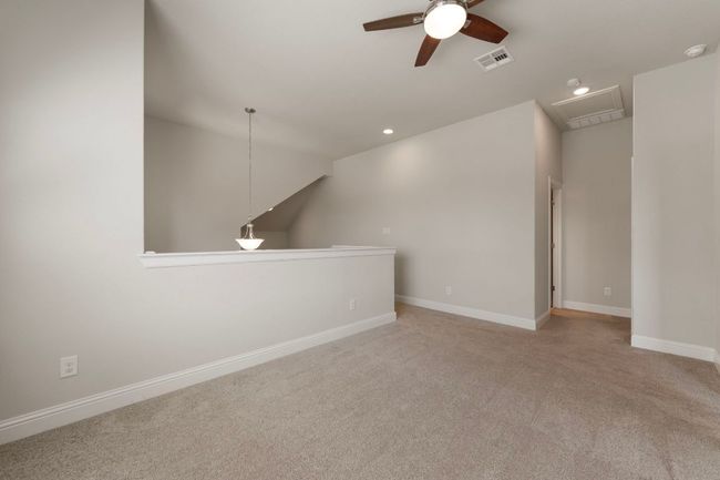 Carpeted empty room featuring ceiling fan, recessed lighting, baseboards, and lofted ceiling | Image 23