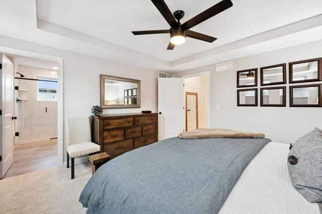 Retreat to the luxurious primary suite featuring a spacious layout, spa-inspired en-suite with walk-in tiled shower and private water closet, plus a generous walk-in closet for ultimate comfort and convenience. | Image 27