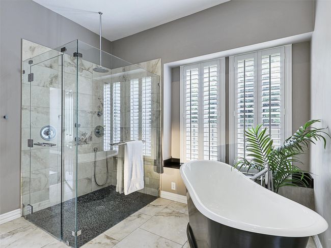 Full bath with a stall shower, marble finish floors, and a freestanding tub | Image 27