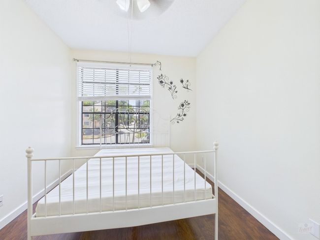 Unfurnished bedroom with wood finished floors and ceiling fan | Image 21