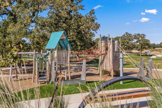 Playground located at The Lake House includes slides, monkey bars, climbing area, and swings! | Image 9