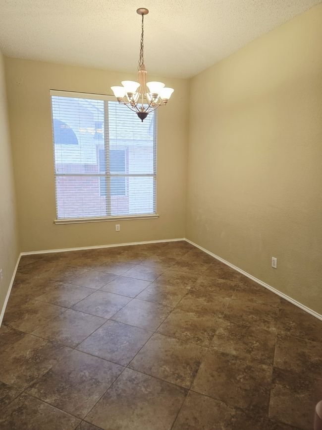 Spare room with a chandelier, baseboards, and a textured ceiling | Image 16
