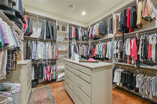 Spacious closet with light wood-style flooring | Image 13