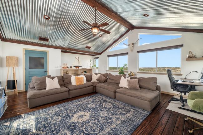 Living room featuring baseboards, beamed ceiling, hardwood / wood-style flooring, and a ceiling fan | Image 21