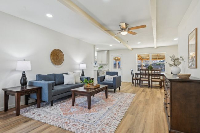 Living room featuring a ceiling fan, light wood-style floors, beamed ceiling, recessed lighting, and baseboards | Image 4