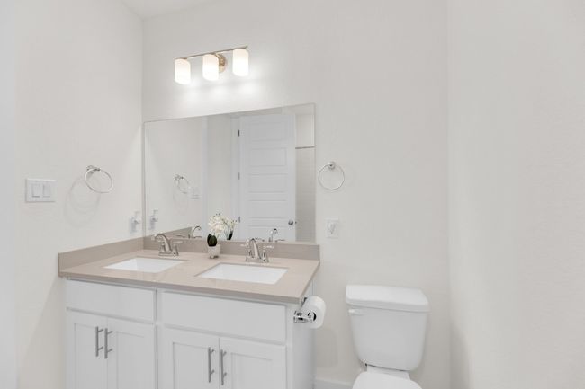 Bathroom featuring a sink, toilet, and double vanity | Image 29