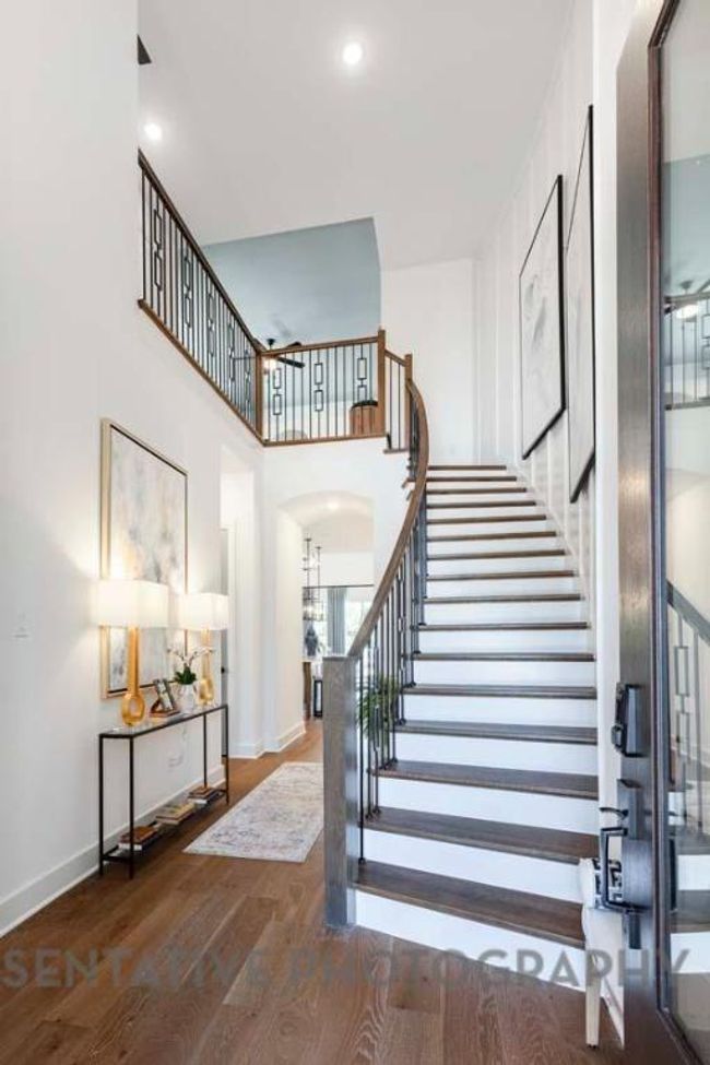 Stairs featuring wood finished floors, arched walkways, and a towering ceiling | Image 28