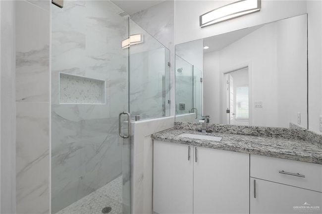 Full bath with a marble finish shower and vanity | Image 9
